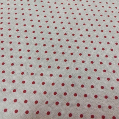 Tecido branco com bolinhas vermelhas pequenas e regulares