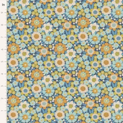 Tecido com padrão floral azul, branco, amarelo e castanho com régua métrica para escala