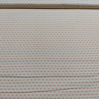 Tecido em rolo bege com padrão de cruzes vermelhas