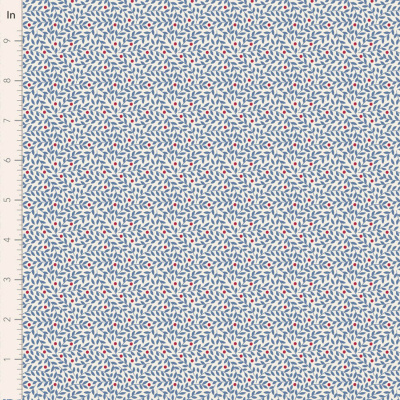 Tecido com padrão de folhas azuis e pontos vermelhos em fundo branco junto a régua em polegadas