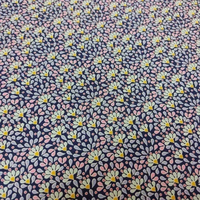 Tecido azul escuro com padrão de pequenas flores brancas, amarelas e rosas.