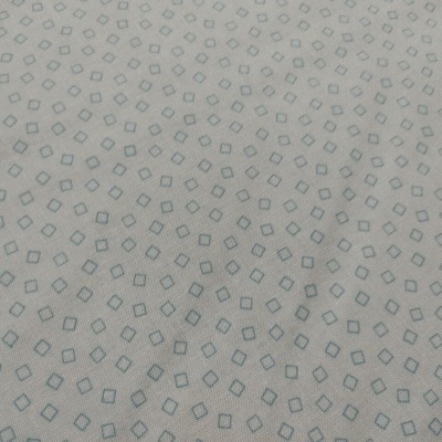 Tecido bege com padrão geométrico azul