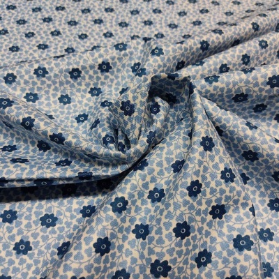 Tecido azul com padrão floral em branco e azul escuro