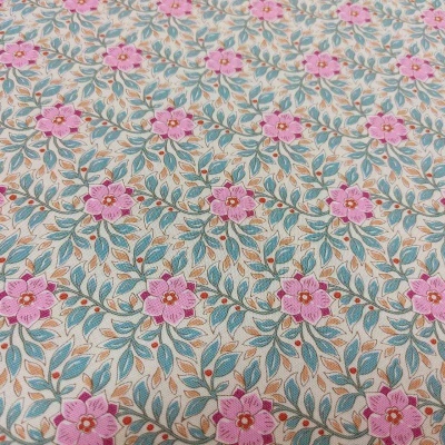 Tecido bege com padrão floral cor-de-rosa e folhas verdes