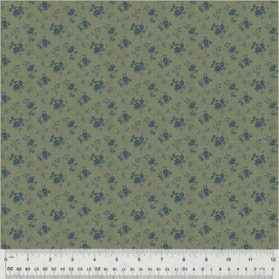 Tecido verde seco com flores azuis e régua de medição