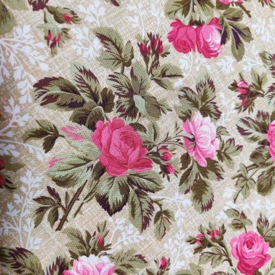 Tecido floral com rosas rosas e folhas verdes sobre fundo bege claro