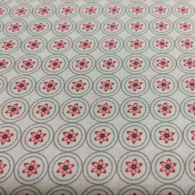 Tecido bege com padrão de círculos cinzentos e flores cor-de-rosa