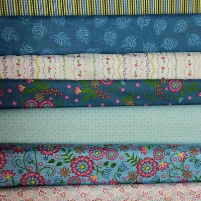 Tecido empilhado com padrões florais, riscas e folhagens em várias cores