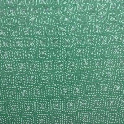 Tecido verde com padrão de quadrados de pontos brancos