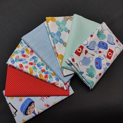 Sete panos de tecido com padrões coloridos médicos sobre fundo preto.