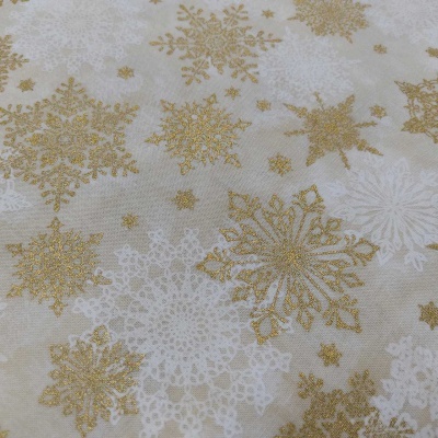 tecido decorativo com flocos de neve dourados e brancos