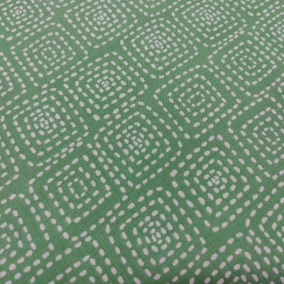 Tecido verde com padrão geométrico branco em círculos quadrados