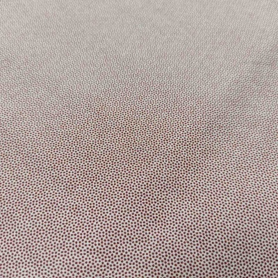tecido bege com pontos castanhos pequenos