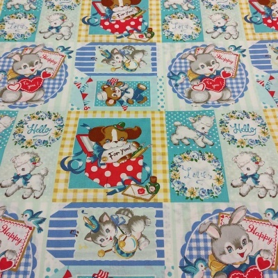 Tecido estampado infantil com desenhos de animais e textos em quadrados coloridos