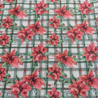 Tecido quadriculado verde e branco com flores vermelhas de poinsétia