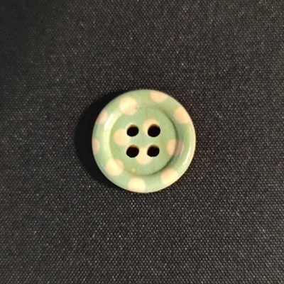 Botão redondo verde com bolinhas brancas