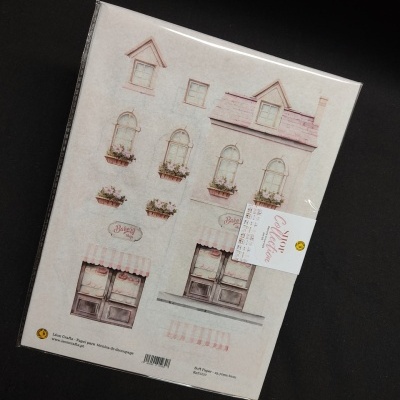 Kit artesanal de papel com design de janelas e portas vintage embalado em plástico.