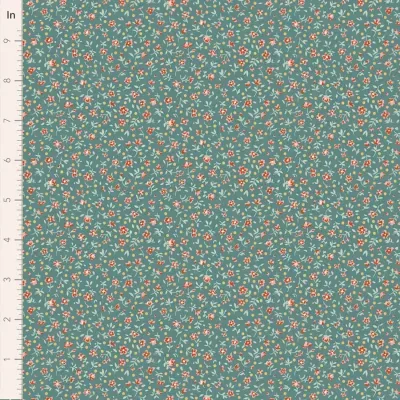 Tecido azul esverdeado com padrão de pequenas flores coloridas e régua ao lado