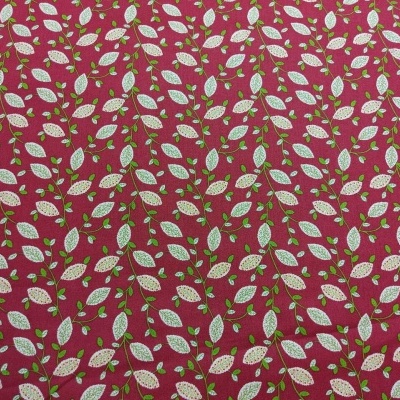 Tecido com folhas brancas e verdes em fundo vermelho