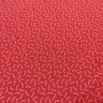 Tecido vermelho com padrão de pequenos ramos brancos