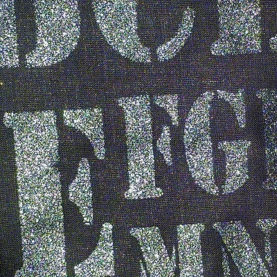 Tecido preto com letras brancas grandes e textura visível