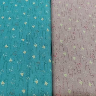 Tecidos azul e lilás com padrão de pedras em forma de coração e quadradas