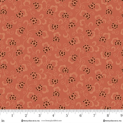 Tecido terracota com padrão floral castanho e bege e régua para escala