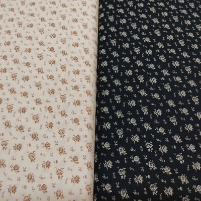 tecidos floral bege e preto com pequenas flores