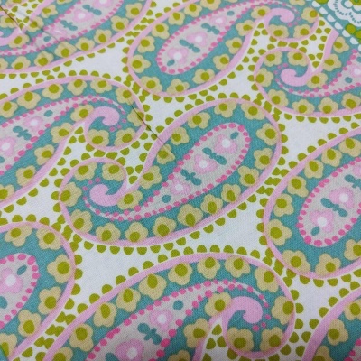 Tecido com padrão de folhas coloridas em verde-limão, rosa, azul e branco