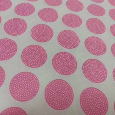 Tecido branco com padrão de círculos rosa com pontos em branco