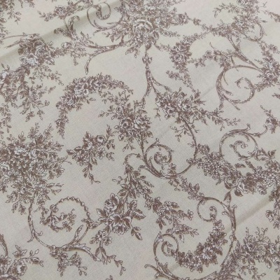 Tecido bege com padrão floral castanho claro.