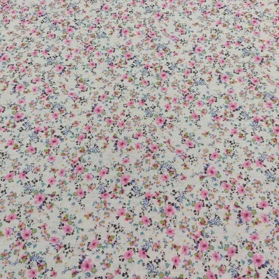 Tecido bege claro com padrão floral colorido