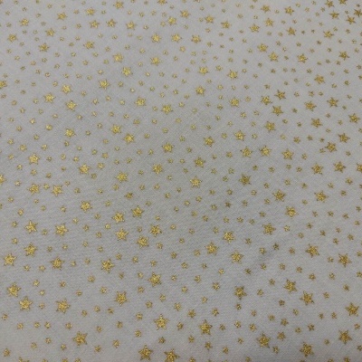 Tecido branco com estrelas douradas pequenas