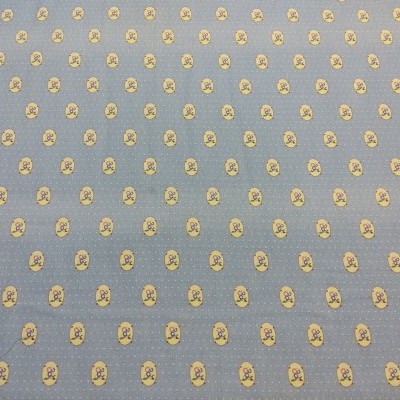 Tecido azul com padrão de pequenas faces amarelas repetidas