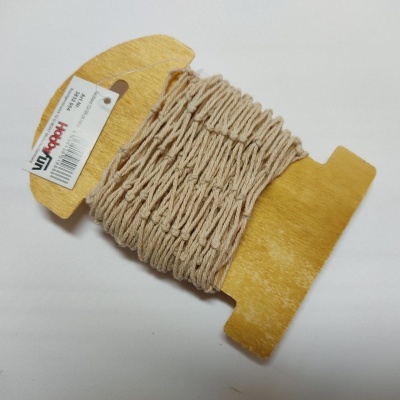 Cordão de algodão bege enrolado em placa de madeira com etiqueta Haboli.