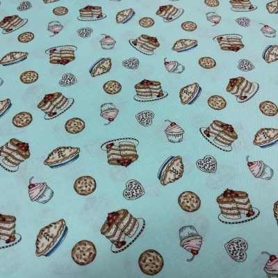 Tecido azul com padrão de sobremesas coloridas