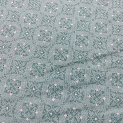 Tecido verde-azulado com padrão floral repetitivo