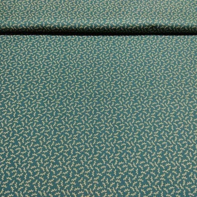 Tecido verde com padrão de folhas creme enrolado