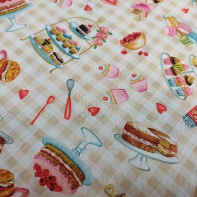 Tecido com ilustrações de bolos, cupcakes e utensílios de pastelaria sobre fundo xadrez bege.