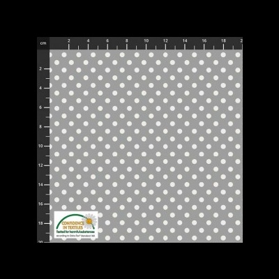 Tecido cinzento com bolinhas brancas e régua de medição.