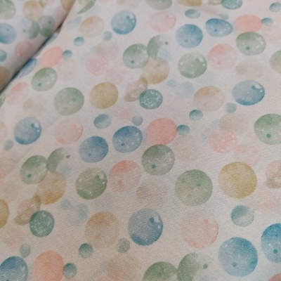Tecido branco com bolinhas coloridas em tons pastel