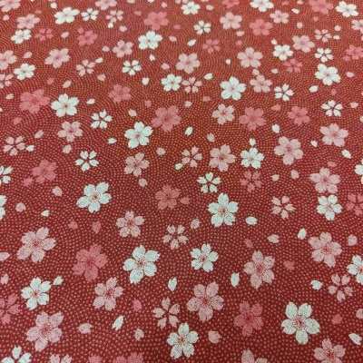 Tecido vermelho com padrão floral branco e cor-de-rosa