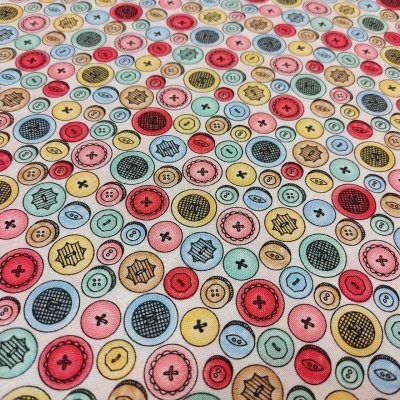 Tecido estampado com padrão colorido de botões redondos variados sobre fundo branco