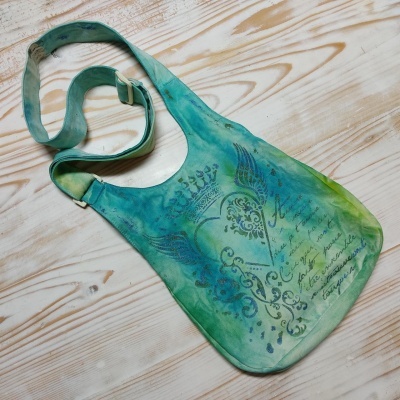 Mala de ombro em tecido verde e azul com estampa preta e alça ajustável