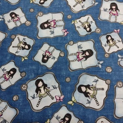 Tecido azul com padrão de bonecas estilizadas e elementos decorativos