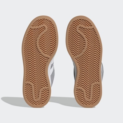 Solas de sapatos desportivos castanhas claras com padrão zig-zag em fundo branco