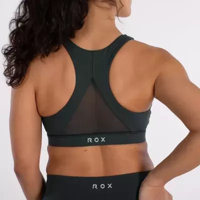 Top desportivo feminino preto com rede transparente e logo ROX na parte de trás.