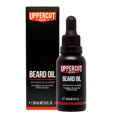 Frasco preto e embalagem preta com detalhes vermelhos de óleo para barba Uppercut Deluxe