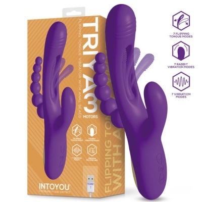 Vibrador roxo de silicone com duas partes, em frente a uma caixa com texto e ícones