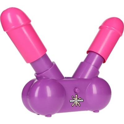 Brinquedo plástico roxo e rosa com duas estruturas fálicas, botão central com texto CUM ON FACE